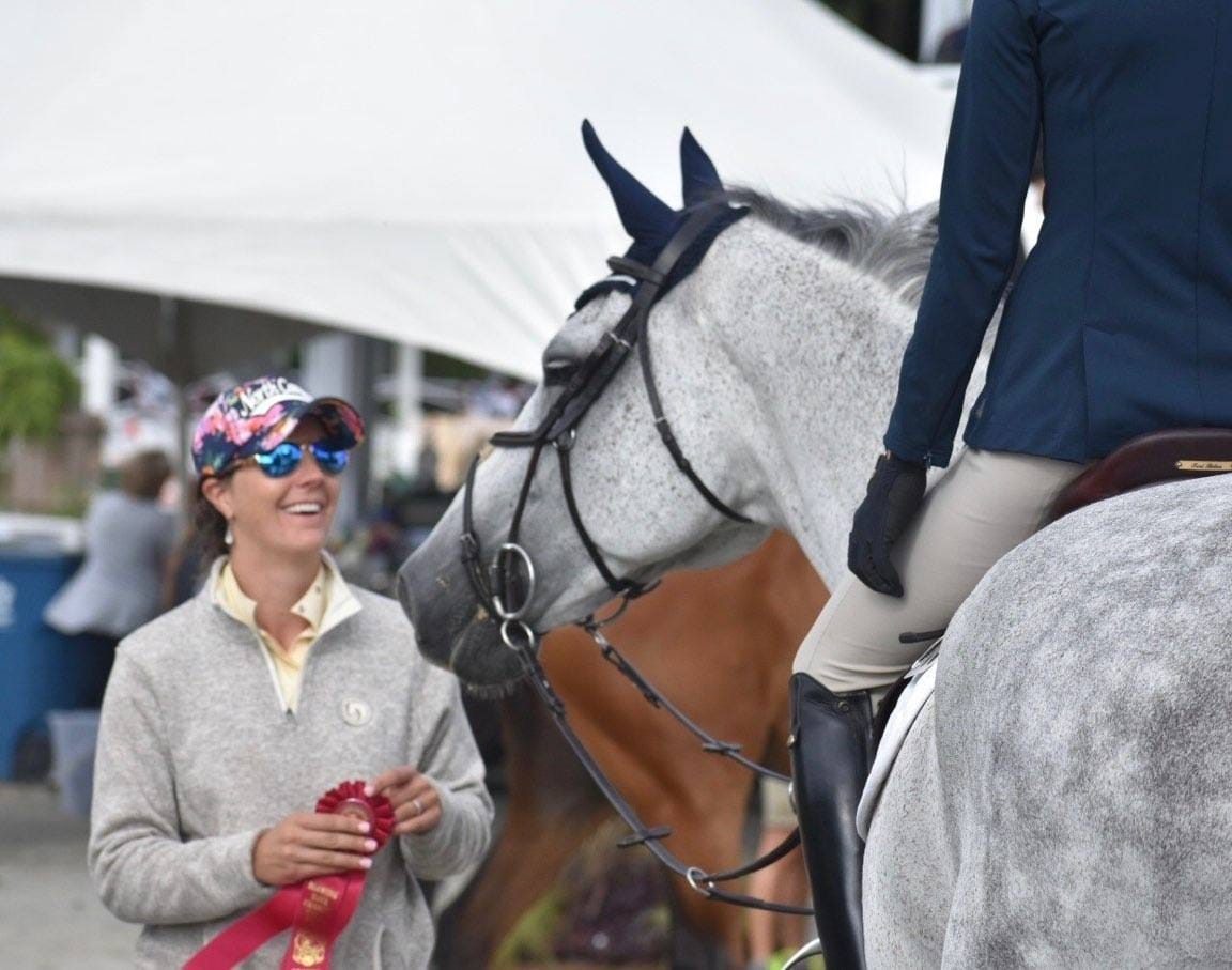 Emily with a student at a horse show